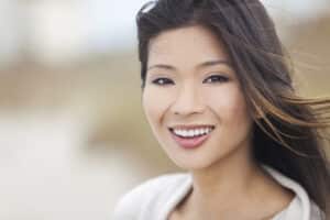 Chinese woman with gorgeous smile and great teeth benefits from cosmetic dentistry.