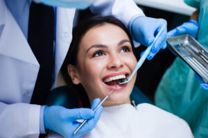 A woman smiling while getting gum disease treatment in Houston, TX