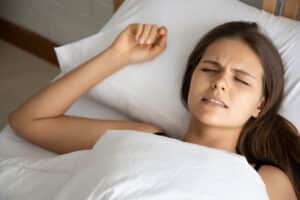 Woman grinding her teeth at night