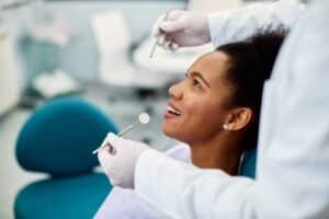 Woman smiling during full-mouth reconstruction in Houston